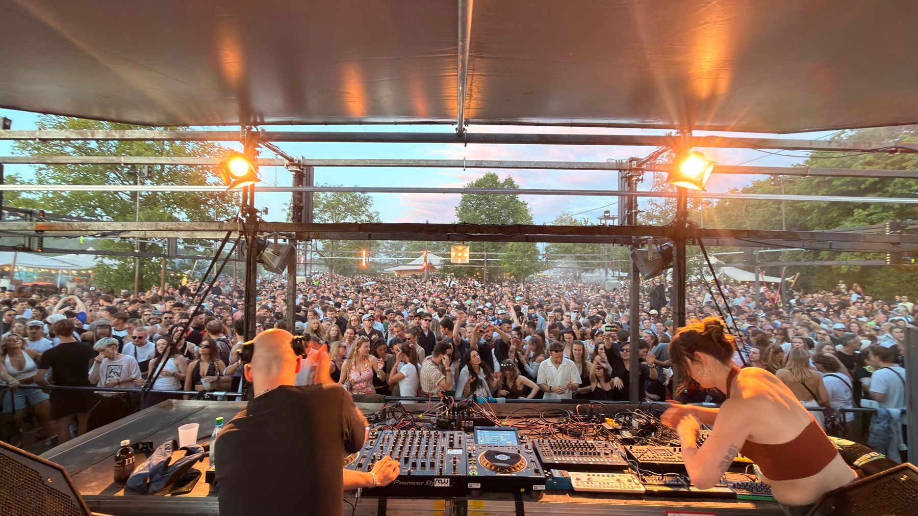 View from the DJ booth over the crowd at sunset